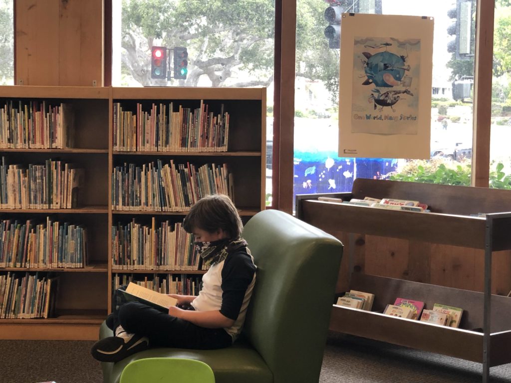 boy reading in the library